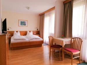 圣卡尼兹Strandpension Liane的酒店客房配有一张床铺和一张桌子。