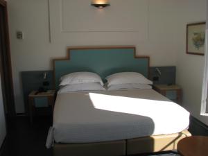 韦内雷港贝维德雷酒店的一间卧室配有带白色床单和枕头的床。
