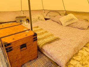 奥泰佩Murimäe Winery glamping的一间卧室配有一张床和一杯葡萄酒