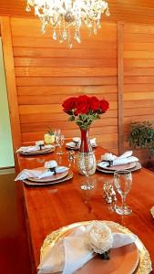 新文达移民镇Recanto Della Mata的一张红玫瑰花的木桌,放在花瓶上