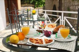索伦托La Magnolia Sorrento - City Centre Hotel的一张桌子,上面放着一盘食物和橙汁
