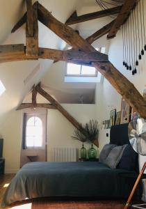 贝叶La Tour Bayeux的卧室配有一张床铺,位于带木梁的房间