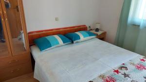 马林斯卡克利萨诺威卡公寓的一间卧室配有一张带蓝色和白色枕头的床