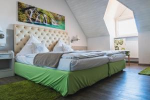 阿勒斯贝格卡腾贝克酒店的一间卧室配有一张大床和大床头板