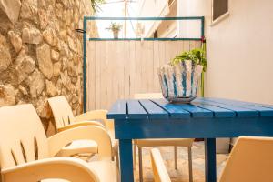 希马拉sofia's cozy rooms的一张带椅子的蓝色桌子和一株植物