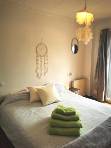 莱斯卡拉Villa Valerie bio & zen的一间卧室配有一张带绿毛巾的床