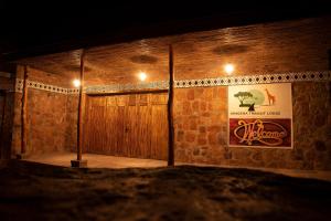 AkageraAkagera Transit Lodge的一间设有木门和墙上的海报的房间