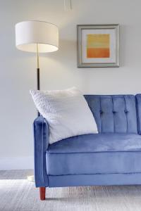 华盛顿Sojourn at DuPont Place的客厅里设有蓝色的沙发,配有灯