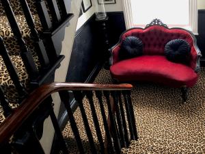 惠特比High Tor Guest House的楼梯旁的红色椅子