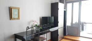 尼斯Villa Angelus的客厅配有电视和带电视的桌子。