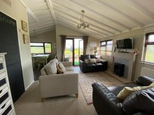 Rew Farm Country & Equestrian Accommodation - Sunrise Lodge的休息区