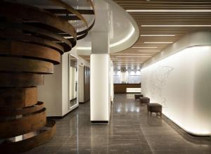 马德里NH马德里贝里酒店的大楼内带椅子的走廊和楼梯