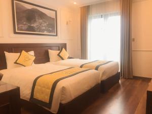 Camellia Luxury Hotel Tam Đảo客房内的一张或多张床位