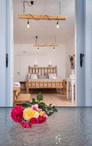 纳克索乔拉Aqua Naxos Apartments & Suites的卧室地板上的一束鲜花