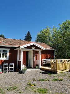 SollerönIdyllisk nybyggd stuga på Sollerön.的一座红色的小房子,设有门廊和院子