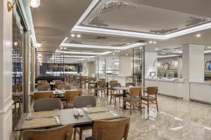 科纳克勒Blue Marlin Deluxe Spa & Resort - Ultra All Inclusive的一间带桌椅的餐厅和一间酒吧