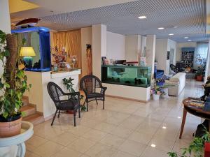 拉帕洛埃尔加托酒店的一间带鱼缸和椅子的客厅