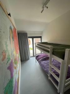 代因泽vakantiehuis Cerise, Luxueus genieten in de Leiestreek的卧室配有双层床和地图
