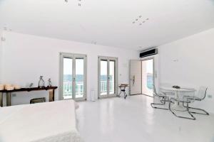 帕罗奇亚卡斯特罗别墅的白色的客房设有床、桌子和窗户。