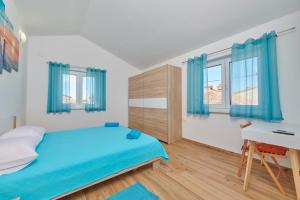 普拉Apartment Olivix的一间卧室配有蓝色的床和一张书桌
