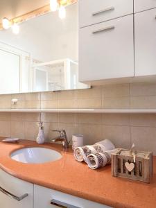 雷卡纳蒂港CLARE HOUSE per una vacanza "CHIC"的浴室配有盥洗盆和带毛巾的台面。