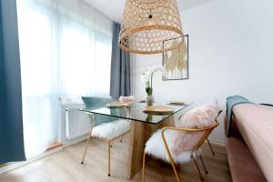 俄斯特拉发Apartmán Ostrava的一间设有玻璃桌和两把椅子的用餐室