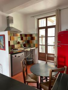 穆斯捷-圣玛丽帕提库里尔德斯鲁米尔莱斯公寓的厨房配有桌子和红色冰箱