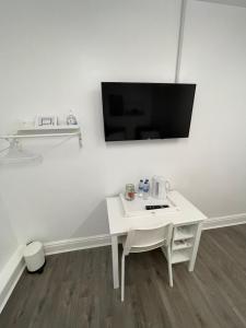 利物浦County road rooms的白色墙壁上的白色桌子和电视机