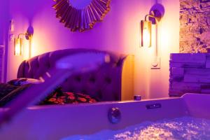第戎Spa Edelweiss的客厅配有带紫色照明的沙发