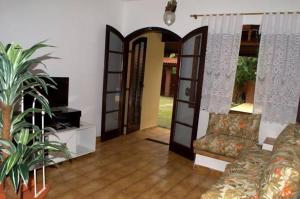 卡拉瓜塔图巴查莱马萨瓜簇度假屋的带沙发和开放式门的客厅