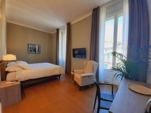科莫SantAgata bed&breakfast的卧室配有床、椅子和窗户。