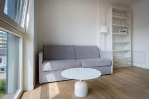 卢加诺Modern apartment in Lugano的客厅配有沙发和桌子