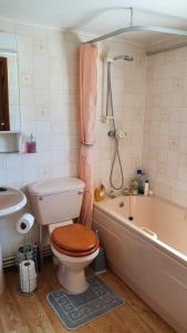 法灵登Huntersfield Chalet的浴室配有卫生间、浴缸和水槽。