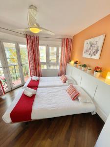 瓦伦西亚Apartamentos Sevilla的一间卧室配有一张带红色毯子的大床