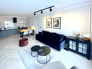 罗兹City Rent Apartments的客厅配有蓝色的沙发和桌子