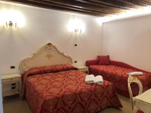 威尼斯莱奥纳多酒店的酒店客房,配有两张床和椅子
