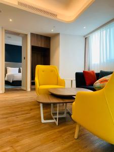 重庆重庆临空智选假日酒店的一间设有黄色椅子、桌子和床的房间