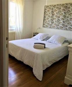 滨海布隆维尔ENTRE TERRE ET MER的卧室配有白色的床和毛巾
