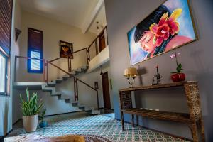 拉戈伊尼亚Dolce Vita Guest House的客厅设有楼梯,墙上挂有绘画作品