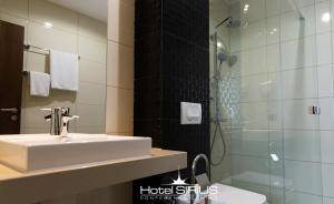 普里什蒂纳天狼星酒店 的一间带水槽和淋浴的浴室