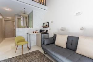罗希姆诺Mitos-Suites的客厅配有沙发和桌子
