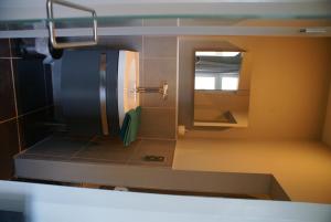鲁汶费利斯宾馆的一个带水槽和镜子的小厨房