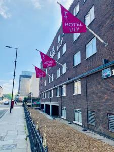 伦敦百合酒店的建筑物一侧的一排粉红色旗帜