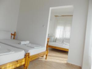 利迈纳里亚Hotel Sgouridis的一间卧室配有两张床和镜子