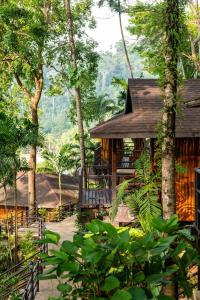 蔻立Baan Krating Khao Lak Resort - SHA plus的树林中树木的房屋