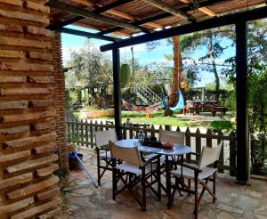 瓦西里科斯阿莱格里亚复式别墅的一个带桌椅的庭院和一个游乐场