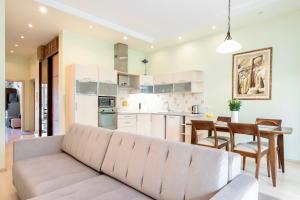 维尔纽斯Spacious apartment with cozy balcony by URBAN RENT的客厅以及带沙发和桌子的厨房。
