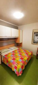 维耶斯泰梅里谷别墅公寓的一间卧室配有一张带彩色毯子的床