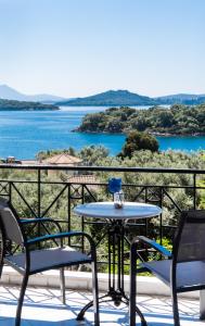 奈德里Spiros Sea View的阳台配有桌椅,享有水景