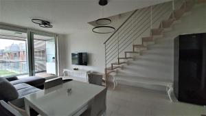 利多迪耶索罗Isola Blu Luxury Apartment的带沙发和楼梯的客厅